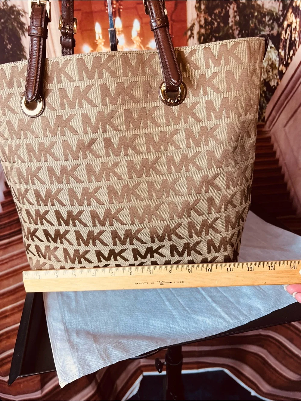 Michael Kors Jet Set tote features monogram canvas, contrasting leather straps